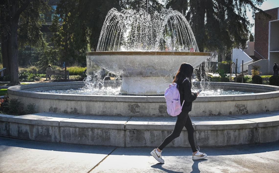 A student walks past the fountain on campus at Fresno State on Friday, Jan. 17, 2025.