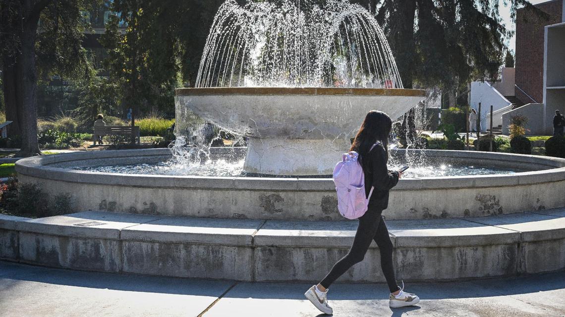 A student walks past the fountain on campus at Fresno State on Friday, Jan. 17, 2025.