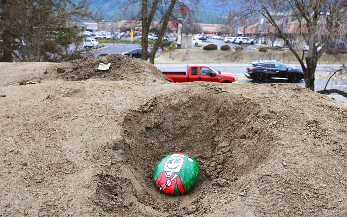 A hand-decorated stone sits on top a 20-foot high mound of dirt dubbed Mt. Chipotle in an Oakhurst parking lot Friday, Jan. 3, 2025. The mound located next to a new Chipotle Mexican Grill may be permanently removed in a few days but until then the community of Oakhurst and others from around the Valley are enjoying the dirt made famous in social media posts.