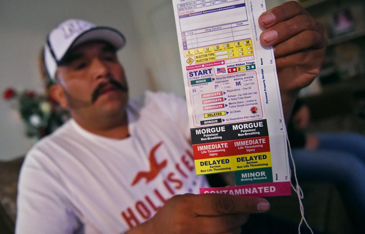 Mardonio Solorio, one of nearly 60 farm workers who were exposed to chemicals near a Dinuba vineyard, holds up a tag he wore hanging from his neck outlining his degree of exposure for medical personnel. Photographed Thursday, Sept. 5, 2019 in Fresno.