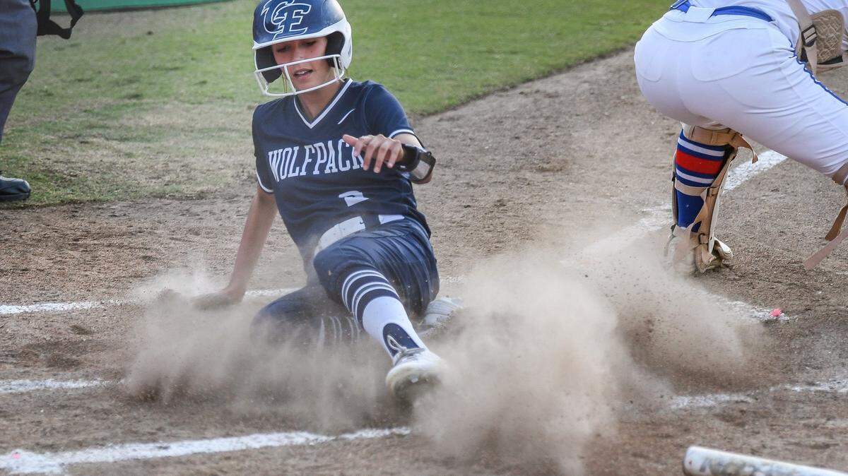 Clovis East’s Savannah Villegas slides over home base for a run on a Wolfpack hit against Buchanan in their game at Buchanan on Friday, April 29, 2022.