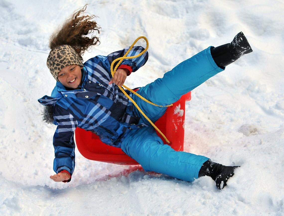 Ten-year-old Jadyn Johnson takes a fun spill off her sled down a slope of fresh snow at the Goat Meadow Snow Play area at Fish Camp near Yosemite National Park on March 4, 2018.