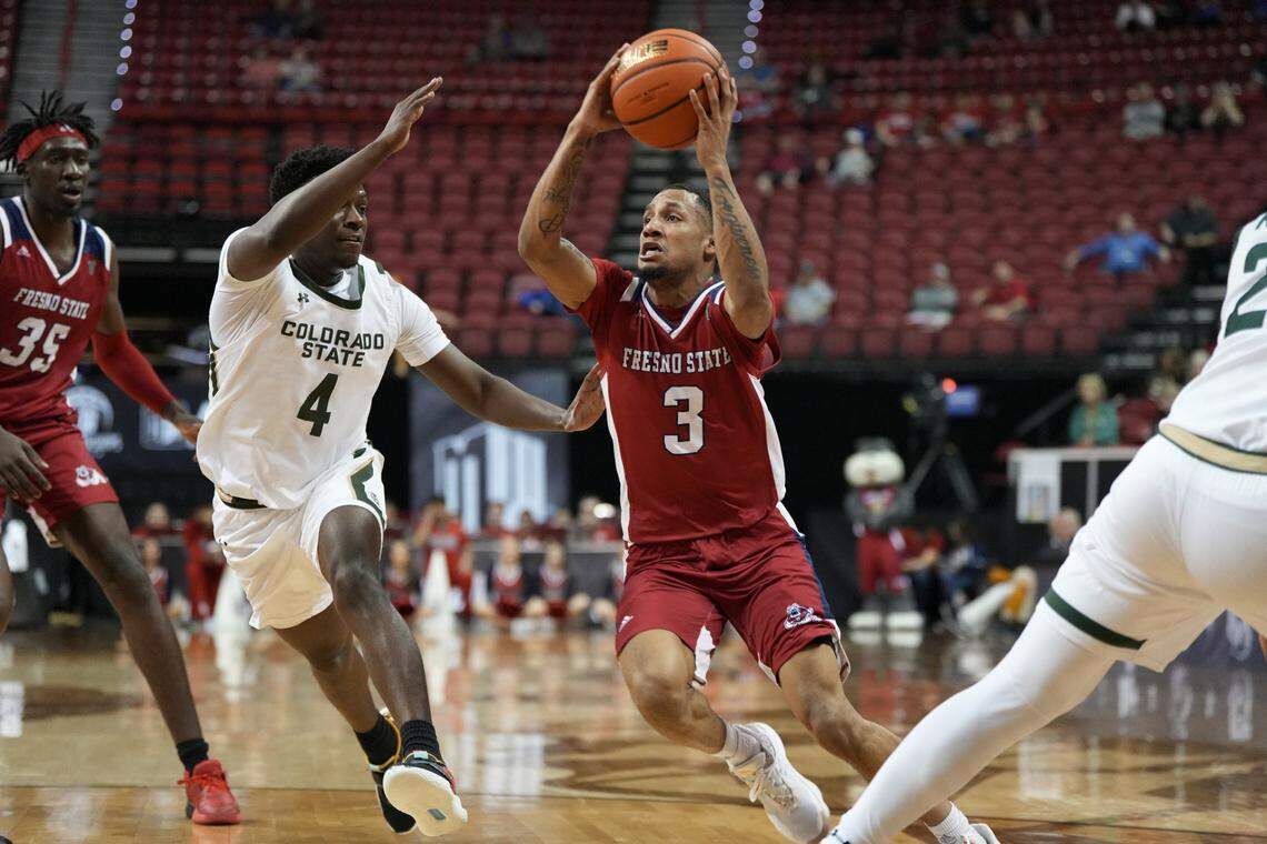 Fresno State point guard Isaiah Hill drives to the basket and by Colorado State guard Isaiah Stevens in the Bulldogs’ 67-65 loss to the Rams in the first round of the Mountain West Conference Tournament.