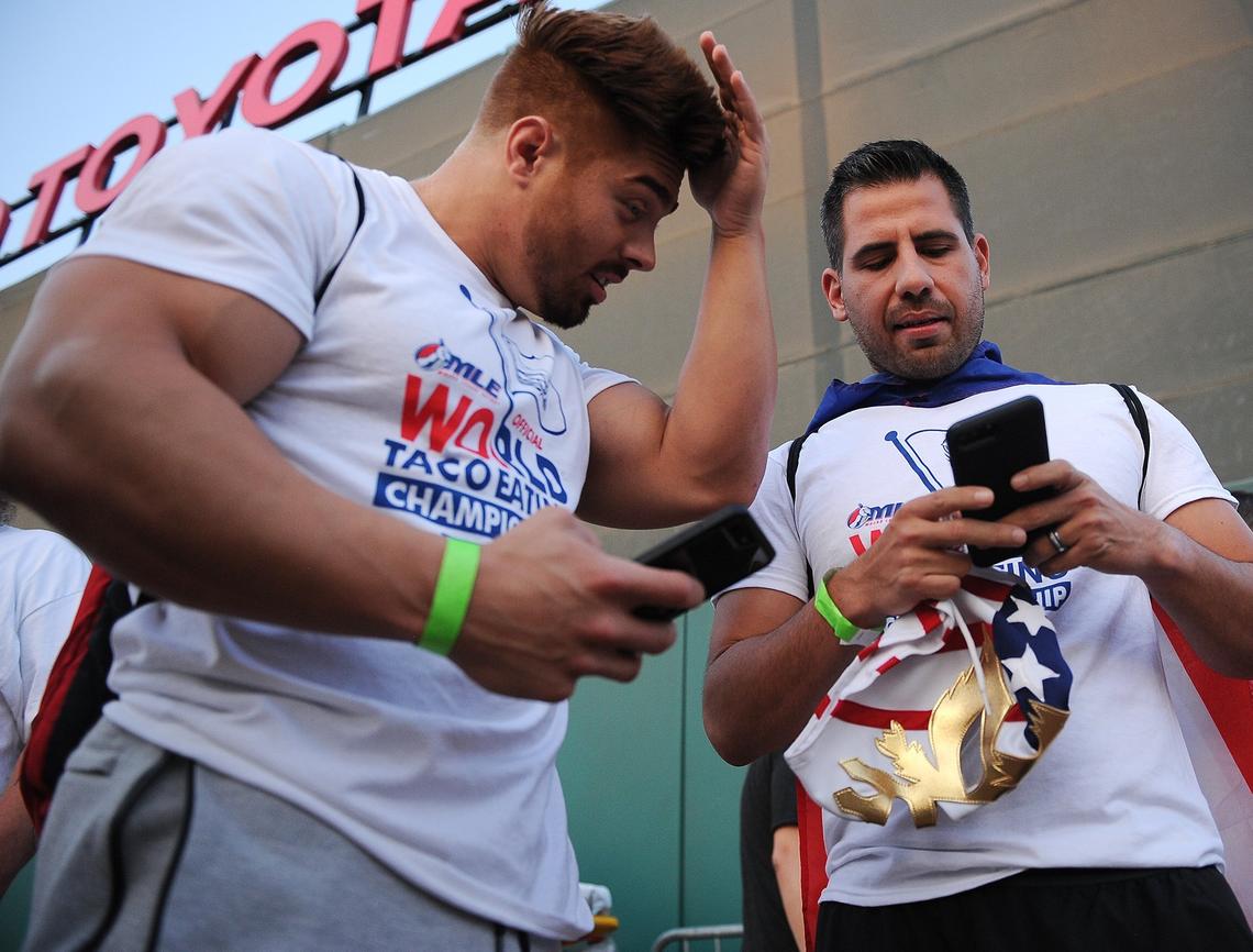 Contestants Zach Armas of Clovis, left, and Pablo Martinez of Visalia exchange Instagram addresses to share photos of themselves at the Taco Truck Throwdown 8 taco-eating contest Friday night, July 20, 2018 in Fresno.
