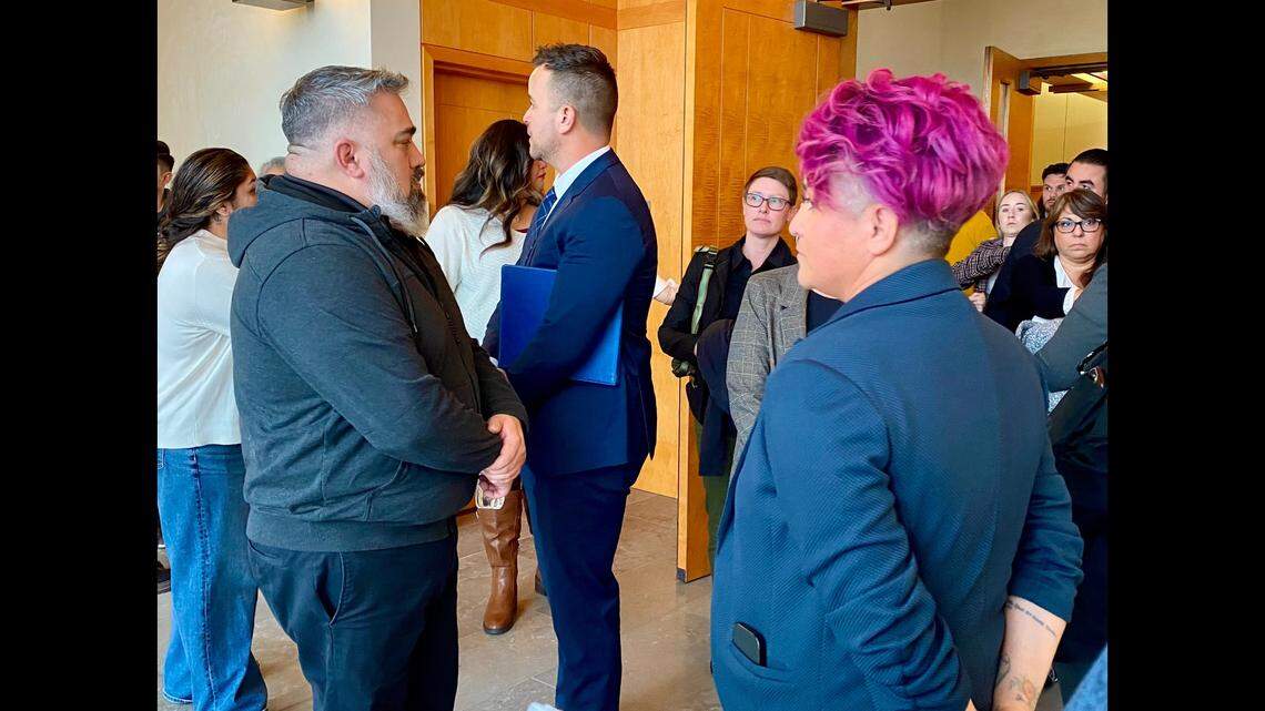 Jake Soberal, center, and Irma Olguin Jr., right, are seen after their sentencing in U.S. District Court on fraud charges.