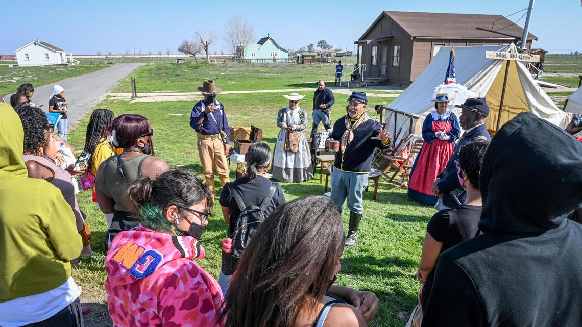 Buffalo Soldier re-enactors and others in period costumes talk to visitors about life in the town of Allensworth in the early 1900s during the 46th Annual Black History Festival at Colonel Allensworth State Historic Park in southwest Tulare County on Saturday, Feb. 12, 2022.