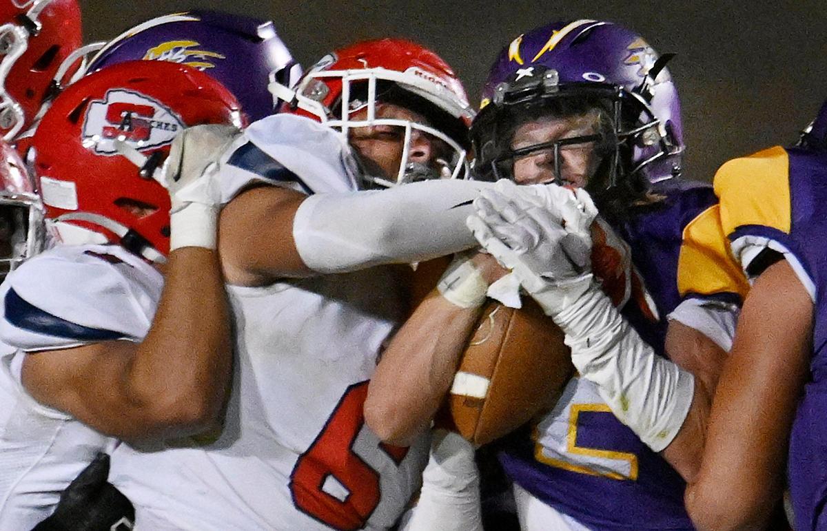 Sanger’s Adolfo Hurtado, left, and Conner Bohlken, cemter, tackle Lemoore’s Spencer Silva, right, Friday, Sept. 8, 2023 in Lemoore. Sanger dominated Lemoore in the 42-13 win.