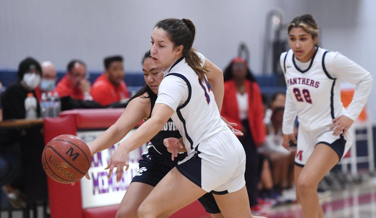 San Joaquin Memorial’s Sienna Evans, right, tries to steals the ball from Clovis East’s Taylor Rombaoa, left, Friday, Feb. 18, 2022 in Fresno.