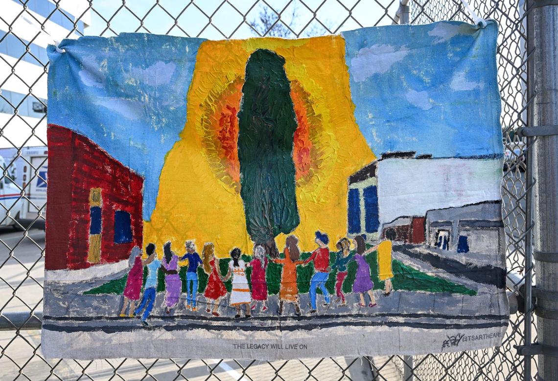 An illustration hangs on a fence near the Legacy Tree giant sequoia during a ceremony honoring the tree before being cut down due to a fungal infection in downtown Visalia, on Thursday, Feb. 21, 2025.