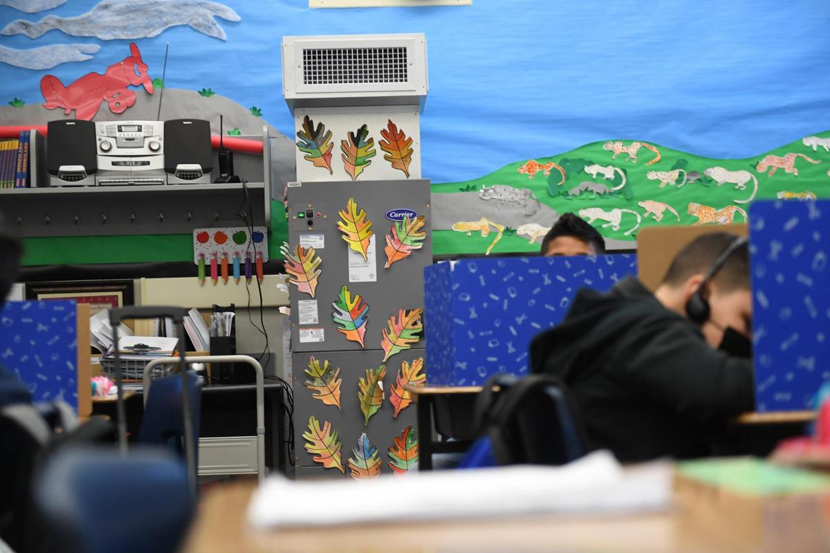 The HEPA-grade Carrier air filtration unit in the class of Clovis Elementary School third grade teacher Renee Mullins nearly blends in with the colorful decor. The system is installed in nearly every indoor space in Clovis Unified. Students help decorate the devices, which helps safeguard their health, by decorating them that helps safeguard their health.