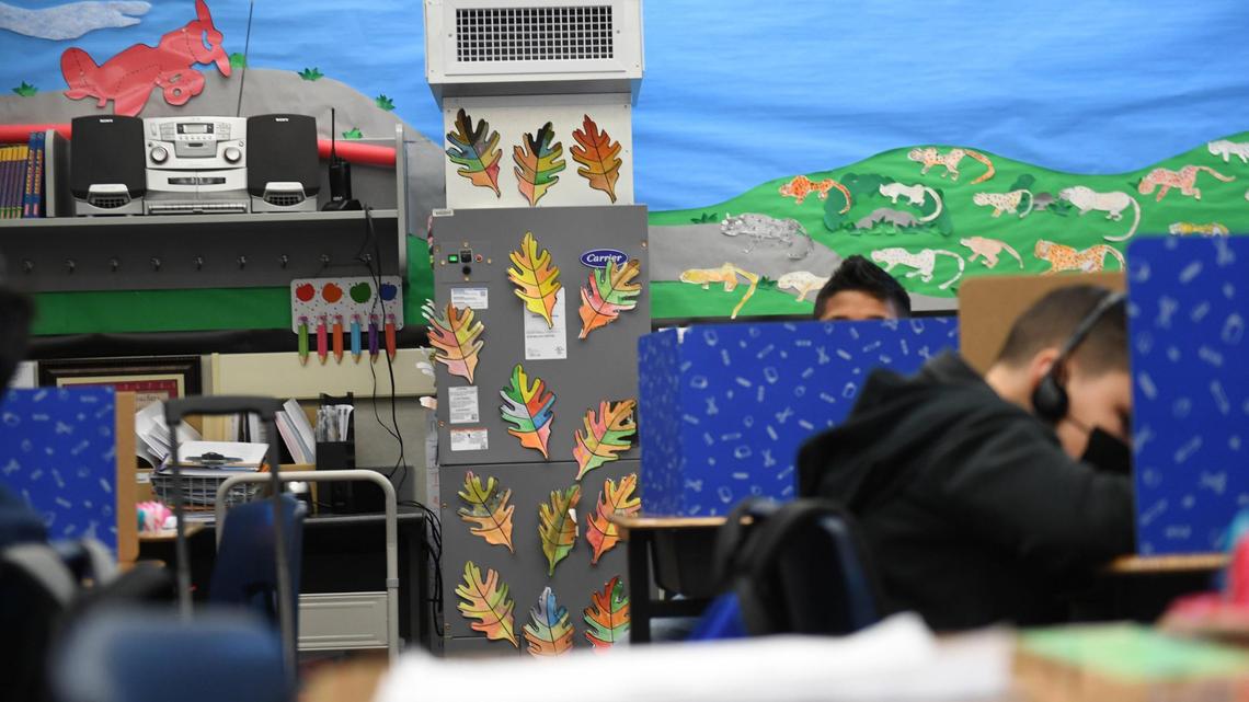The HEPA-grade Carrier air filtration unit in the class of Clovis Elementary School third grade teacher Renee Mullins nearly blends in with the colorful decor. The system is installed in nearly every indoor space in Clovis Unified. Students help decorate the devices, which helps safeguard their health, by decorating them that helps safeguard their health.