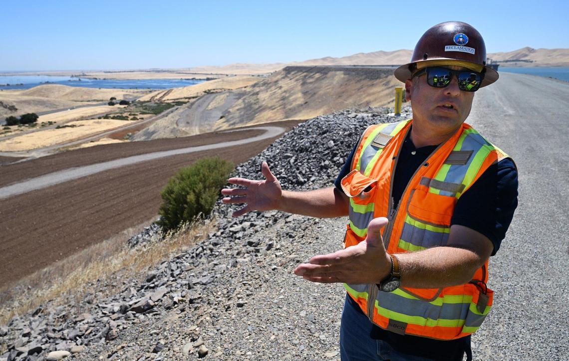 Henry Garcia, construction manager with the Bureau of Reclamation, stands on top of the B.F. Sisk Dam at San Luis Reservoir discussing the construction project which will raise the dam and eventually impact traffic on Highway 152 over Pacheco Pass. Photographed Thursday, Aug. 8, 2024.