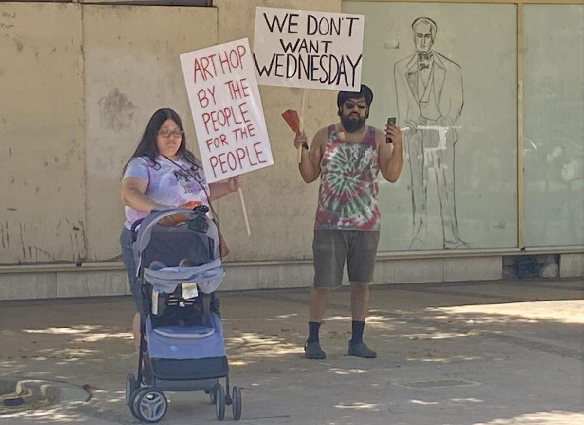 Crystal Rocha and Joseph Rodriguez protest the announcement on Wednesday, Aug. 21, 2024, of Why Not Wednesday, the new offshoot of ArtHop.
