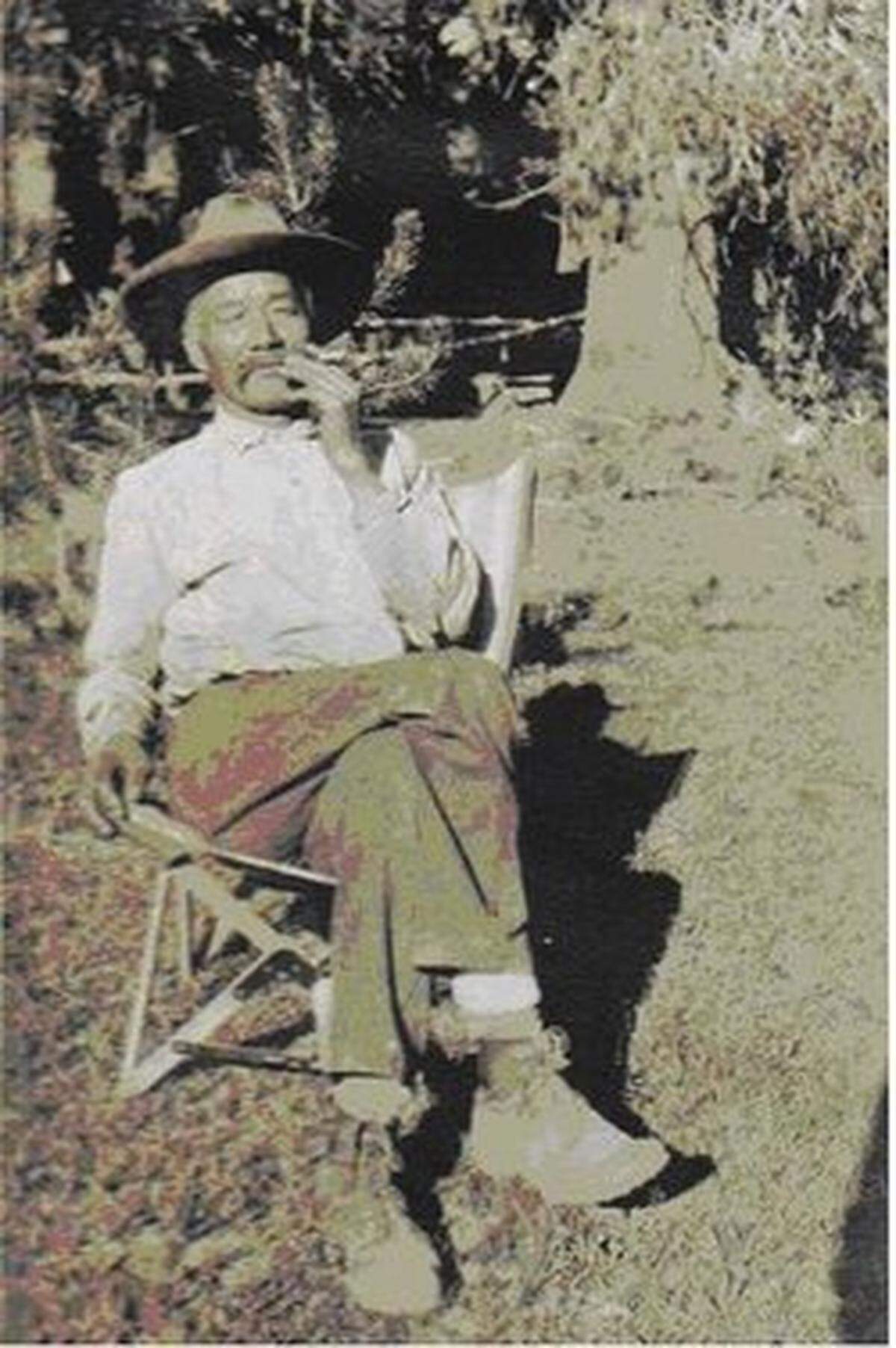 Charley Lee Blasingame smoking outside his house at China Camp, circa 1919.