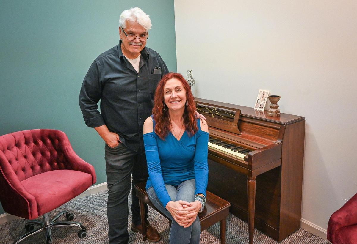 Debi Ruud, owner of Fresno Music Academy & Arts, sits with managing art director John Alden in the Dolly Parton room at their new location in north Fresno on Tuesday, April 19, 2022.