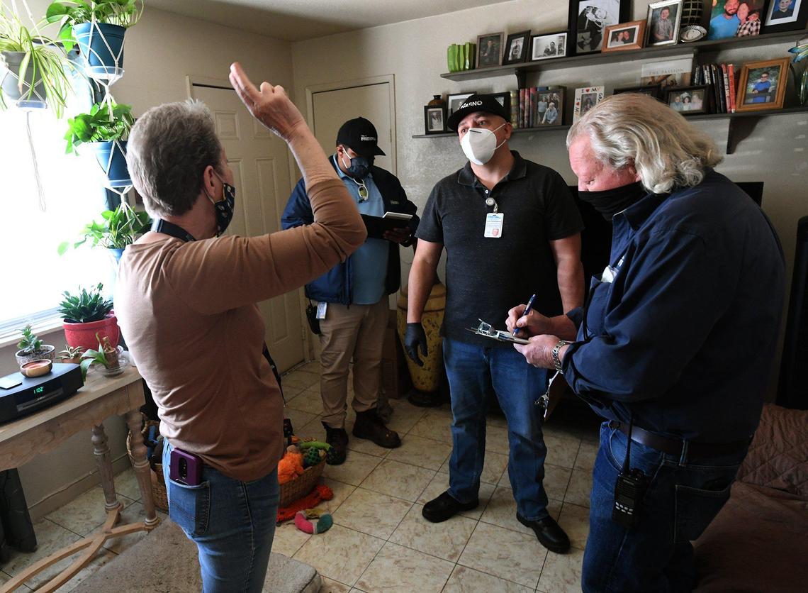 Manchester Arms resident Laura Denies talks with city code enforcement officers during an inspection of the complex, March 31, 2021.