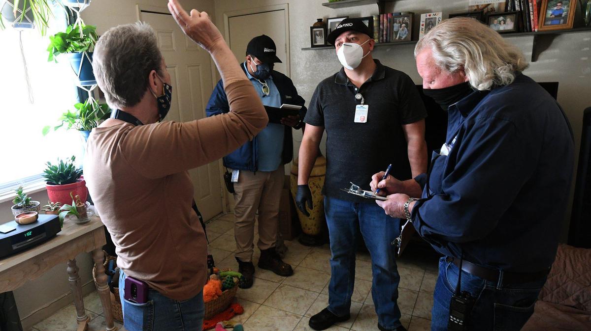 Manchester Arms resident Laura Denies talks with city code enforcement officers during an inspection of the complex, March 31, 2021.
