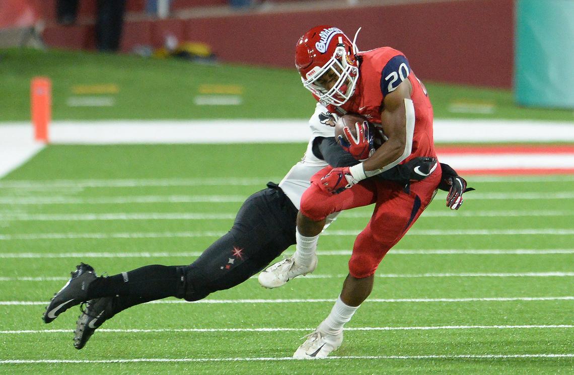 Fresno State running back Ronnie Rivers gets hit by a UNLV defender during their game at Fresno State’s Bulldog Stadium on Friday, Oct. 18, 2019.