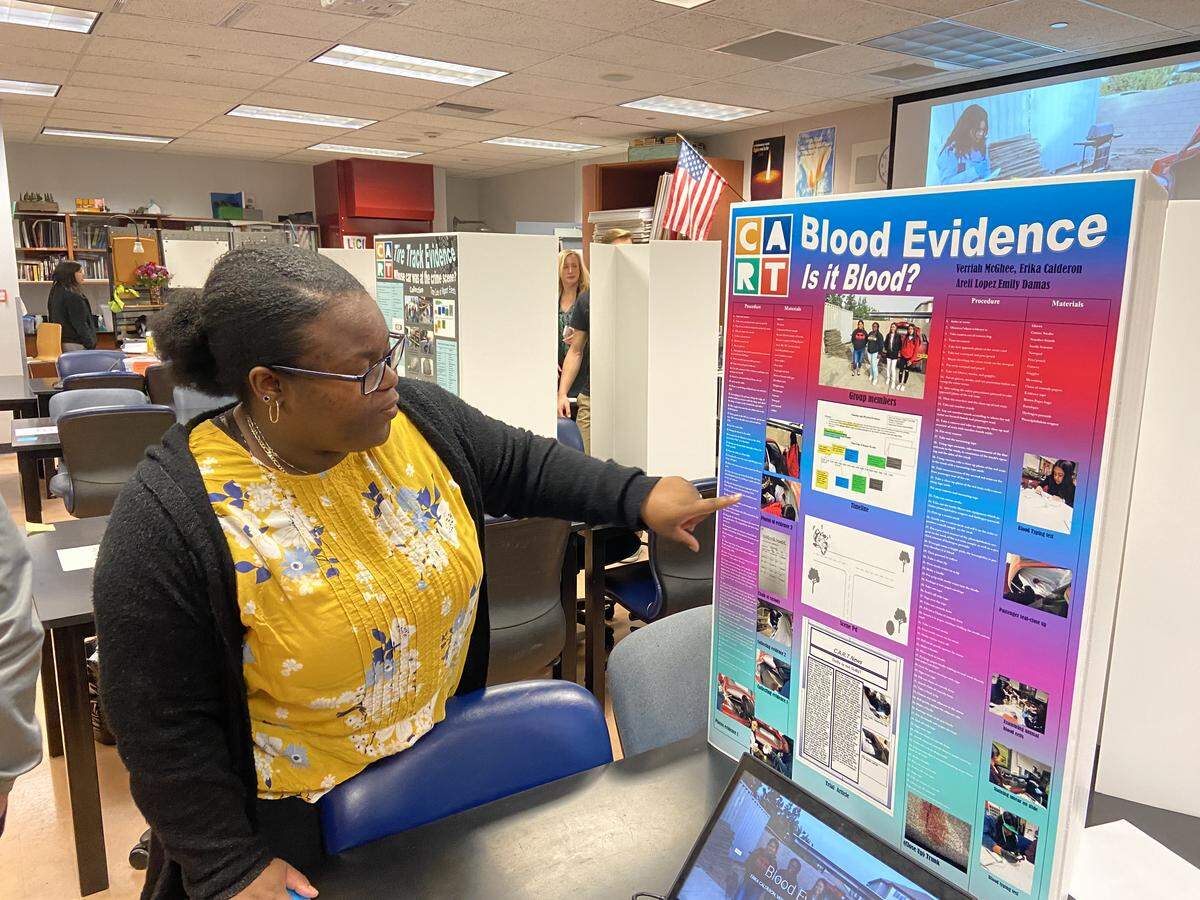 Verriah McGhee, 17, presents her project on blood evidence during The Center for Advanced Research and Technology showcase.