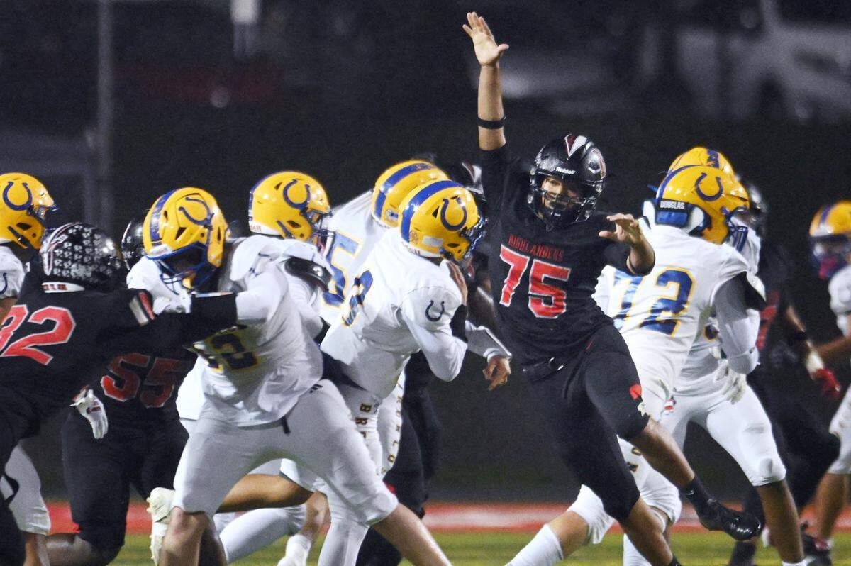 McLane's Nicholas Haros pass rushes the Dos Palos quarterback in the Highlanders' 46-7 routing of the Broncos Friday, Nov. 14, 2025 in Fresno.