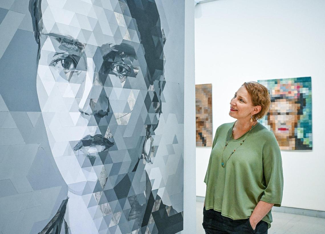 Paula Castadio, who came to Fresno as a student decades ago, looks over the artwork of Michael Azgour at the Fresno Art Museum on Tuesday, June 17, 2025.