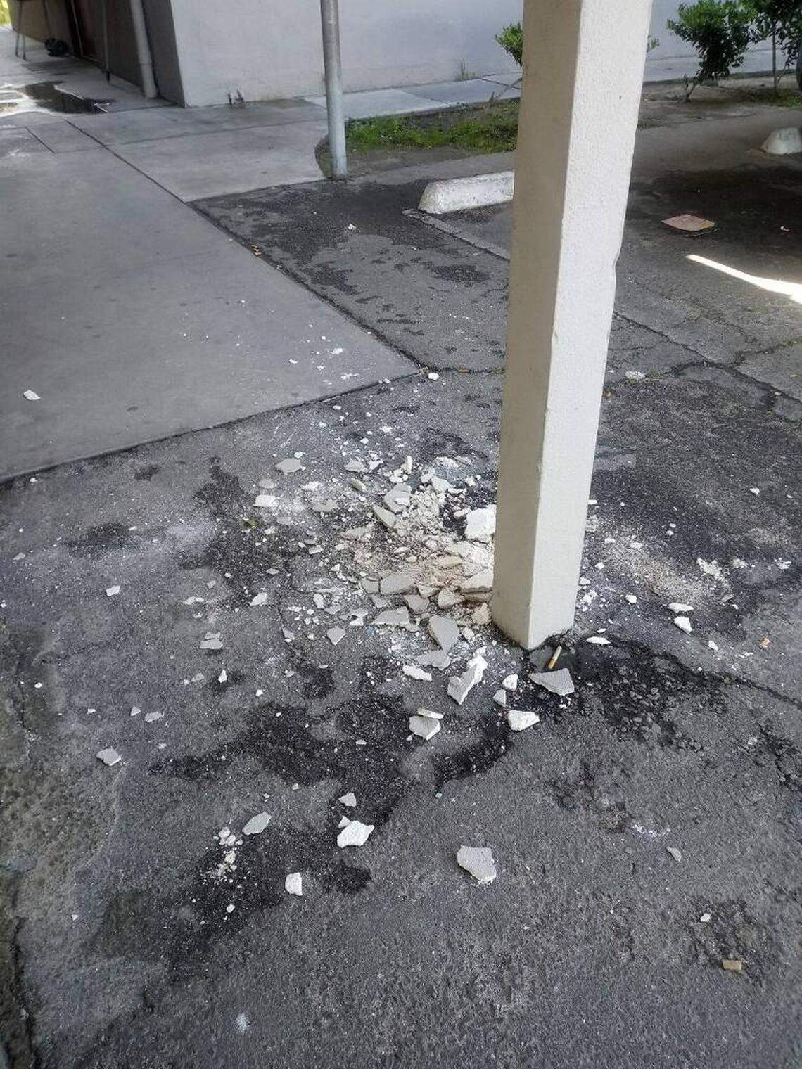 Plaster crumbling from the underside of a walkway at Manchester Arms apartment, as seen March 21. 