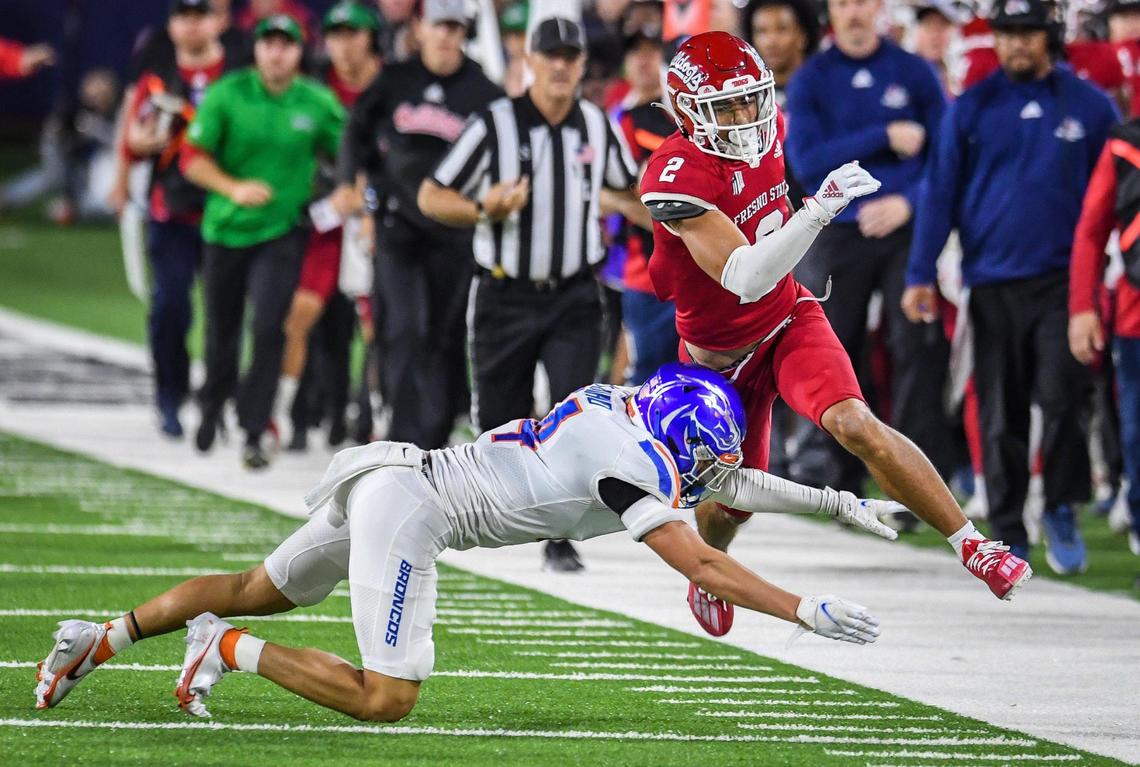 Fresno State’s Zane Pope gets run out of bounds by Boise State’s Kaonohi Kaniho on a short pass play during their game at Bulldog Stadium on Saturday, Nov. 6, 2021.