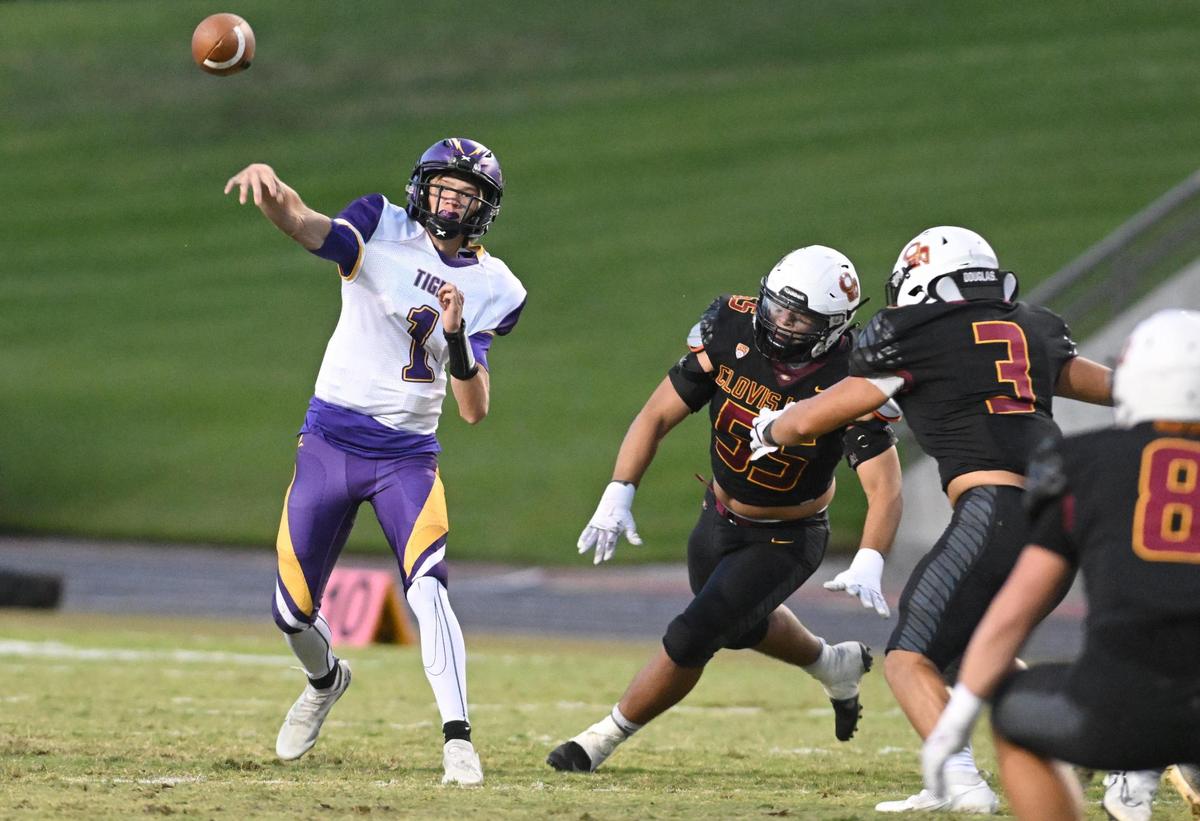 Lemoore quarterback Johnny Cunha throws while getting pressure from the Clovis West defense during their game at Veterans Memorial Stadium on Friday, Sept. 1, 2023.