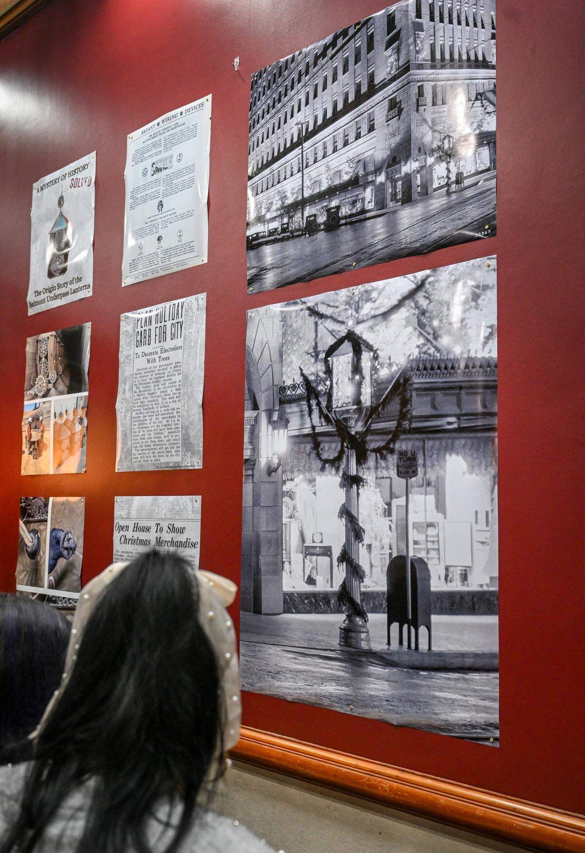 Enlargements of old newspaper articles and photos provide information about the lanterns found earlier this year by CalTrans workers building the California High-Speed Rail project through Fresno, during a press conference at The Archive on Kern on Friday, Dec. 19, 2025. The Fresno City & County Historical Society was able to uncover the mystery of the lanterns which has been used to celebrate the holidays in downtown Fresno nearly 100 years ago. A 1929 Pop Laval photo, right, helped reveal the origins of the lanterns.