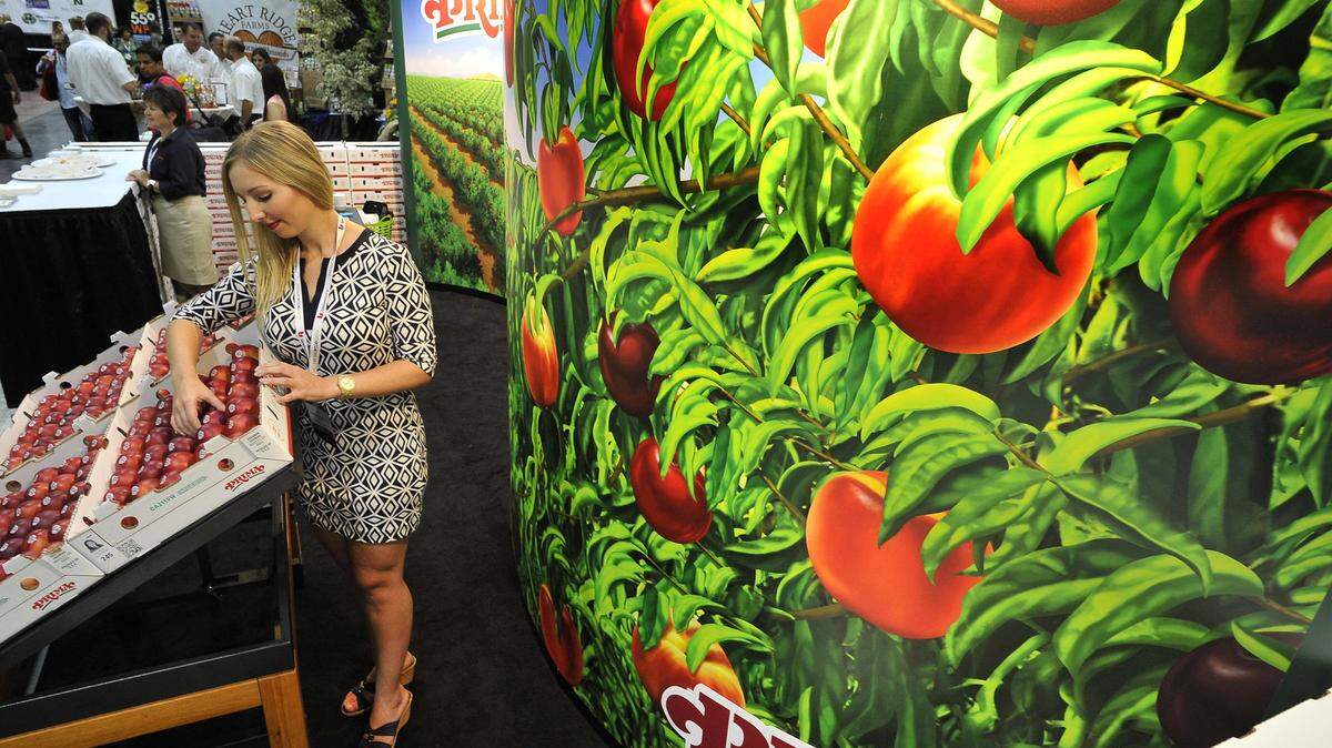 An employee of Gerawan Farming/Prima Brand, arranges fruit during the Fifth annual Fresno Food Expo in 2019.