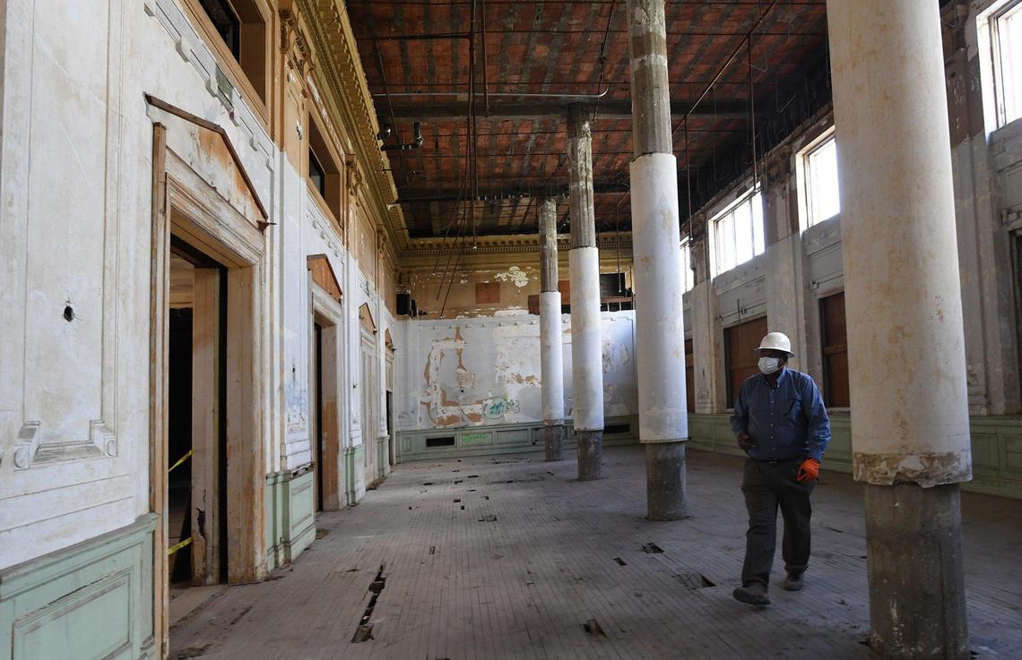 Darius McGee, Construction Manager of the Hotel Fresno renovation, walks through the grand dining room of the historic 1912 hotel, which is undergoing renovation into a 79-unit affordable housing complex, Wednesday July 15, 2020. The work has been slowed by the pandemic in that fewer workers are allowed on site at one time.