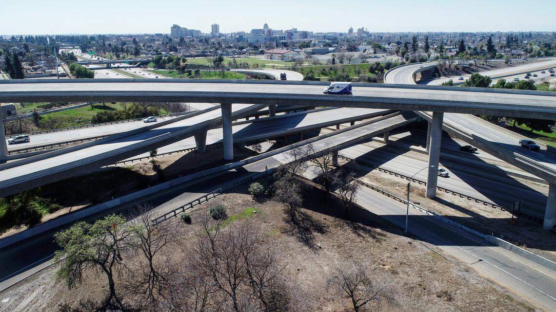 Traffic moves through the Highway 41-180 interchange with downtown Fresno in the background on a warm afternoon last March.