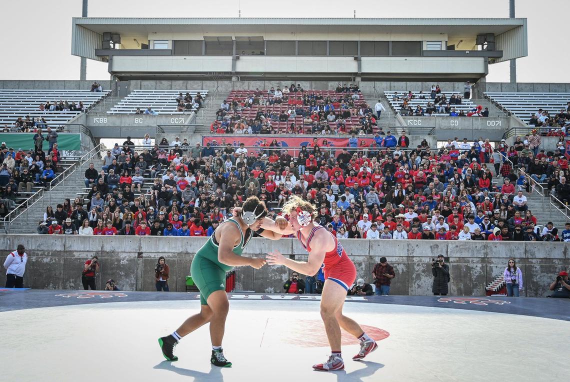 Buchanan’s Caden Rodgers, right, wrestles Adam Farha of Poway in the 222-pound match during their meet at Veterans Memorial Stadium on Saturday, Feb. 5, 2022.