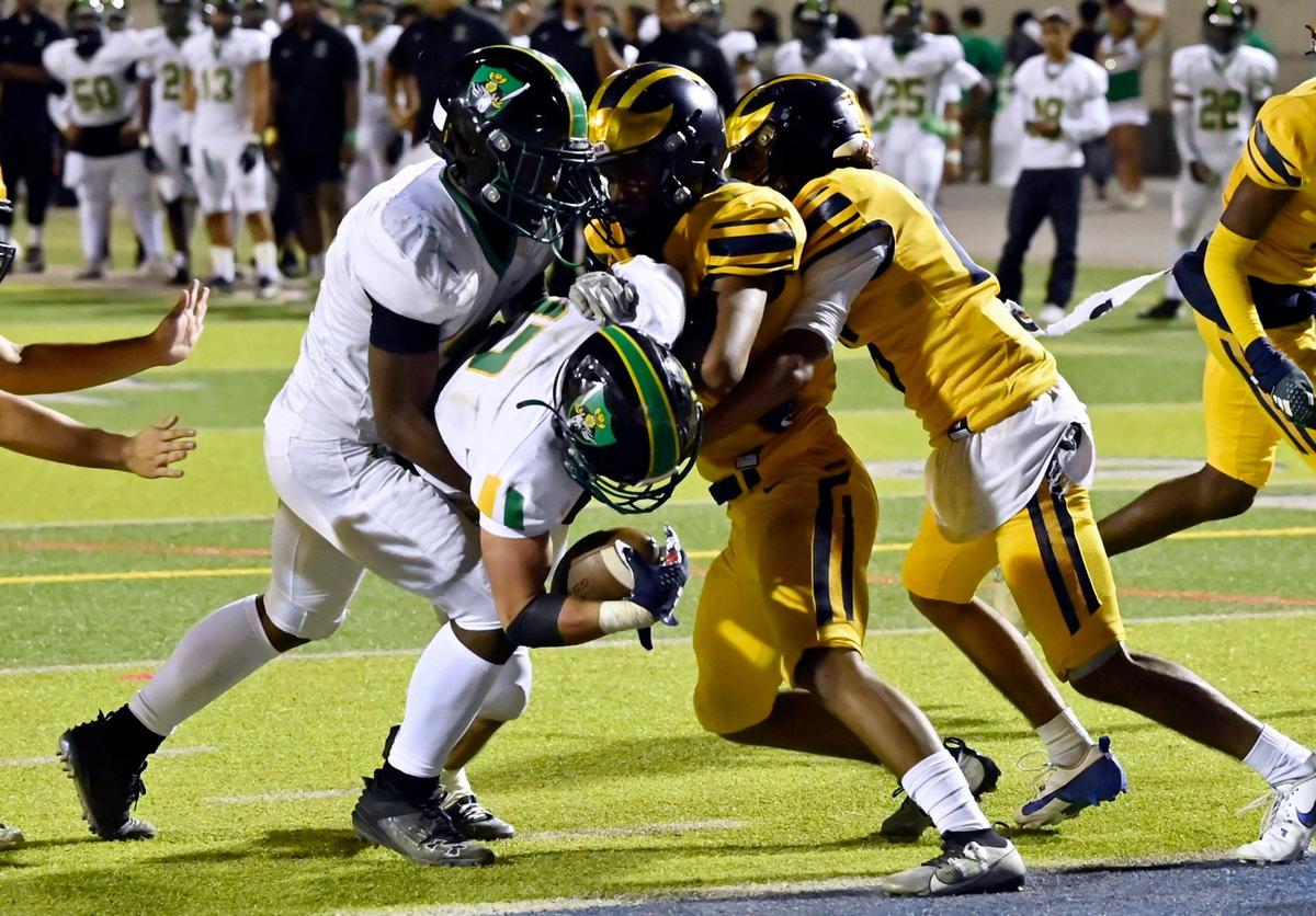 Roosevelt’s Jerry Thomas, left, helps push Dominick Gonzalez over the goal line for a touchdown against Sunnyside Friday, Oct. 4, 2024 in Fresno.