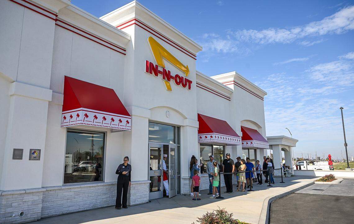 Dine-in visitors wait to enter the new In-N-Out in the Fancher Creek shopping center on Clovis Avenue south of Belmont in southeast Fresno on its opening day, Wednesday, Nov. 12, 2025.