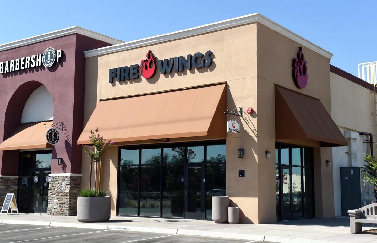 Fire Wings was planning to open at the Marketplace at El Paseo shopping in this Bee file photo from Aug. 4, 2021. Now, the Fire Wings signs are down and Bag O’ Crab restaurant signs have taken their place.