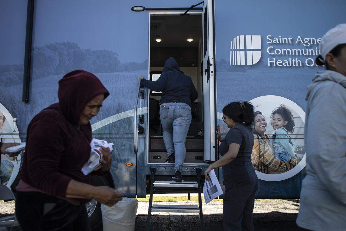 A patient walks into the Saint Agnes Mobile Health Unit mobile clinic, parked in the parking lot of Rojas Pierce Park in Mendota on May 21, 2025. Photo by Larry Valenzuela, CalMatters/CatchLight Local
