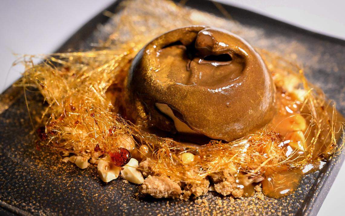 Golden moonbeam ice cream and chocolate cake coated in a golden chocolate dome with hot caramel is served during a media event to promote The PM Lounge, a new members-only club that promises to bring high-level dining experiences and live entertainment to its guests.