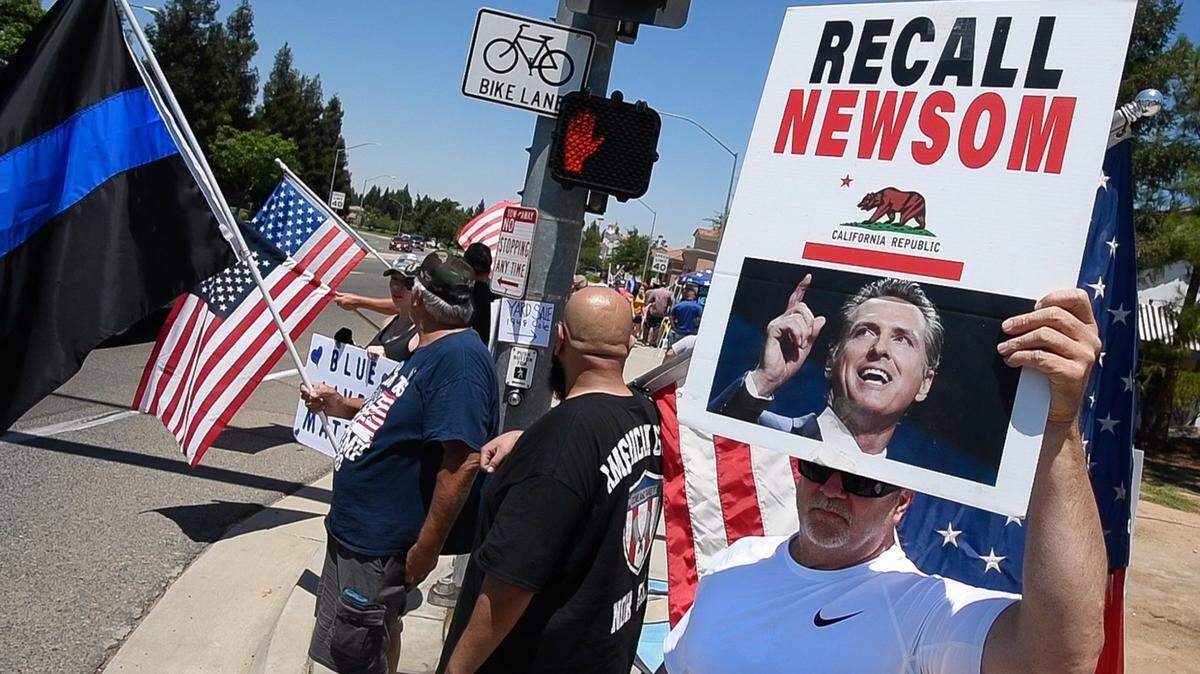 Around 75 protesters at Shepherd and Cedar avenues promote a recall of California Gov. Gavin Newsom and support President Donald Trump on Saturday July 18, 2020. The event was sponsored by the Fresno County California Republican Assembly.