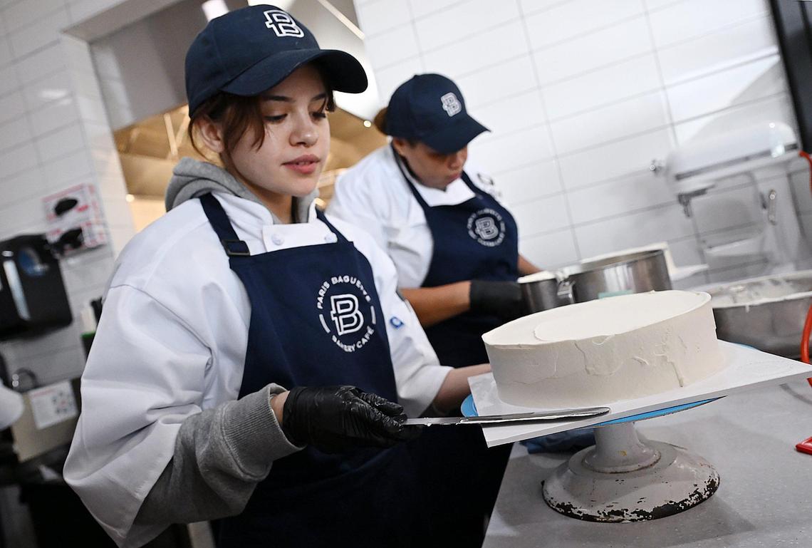 West Hills College culinary student Erika Lourenco, left, trains in the cake department as a “caker” Thursday morning as Paris Baguette prepares for its opening Saturday, March 22 in Fresno’s Villaggio Shopping Center. The French-inspired bakery is part of a chain that will offer unique pastries baked daily as well as salads, sandwiches, coffee drinks, cakes and more. Photographed Thursday, March 20, 2025 in Fresno.
