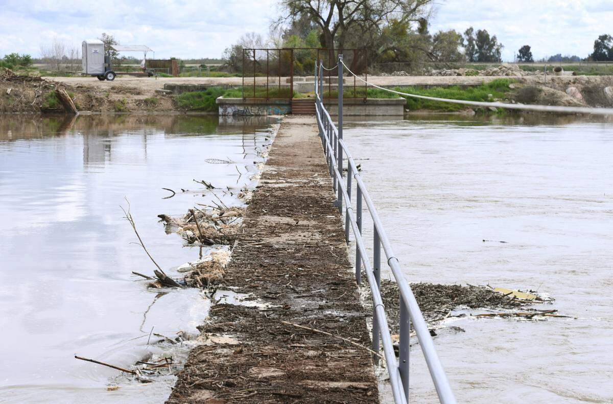 A fork of the lower Kings River flows through and almost tops Crescent Weir south of Riverdale, in southern Fresno County, before turning northwest Monday afternoon, March 20, 2023.