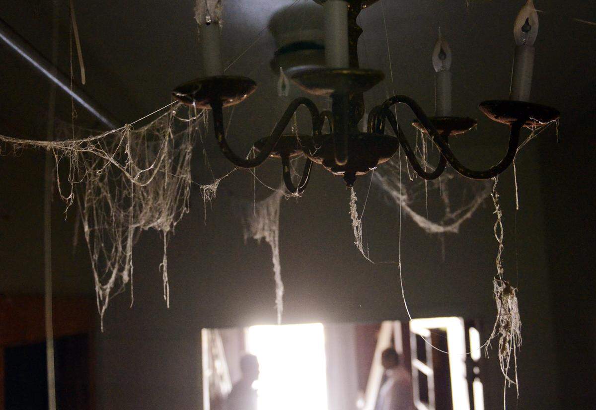 A chandelier located beyond the entryway at Wolfe Manor, a house along Clovis Avenue purchased years ago by Todd Wolfe to create a seasonal Halloween attraction. Wolfe soon realized the home used to be the Clovis Sanitarium, replete with stories of its own original hauntings. Wolfe said he has reached an agreement with the City of Clovis to raze the structure and create a hotel on the property. Photographed on Thursday, May 15, 2014 in Clovis, Calif.