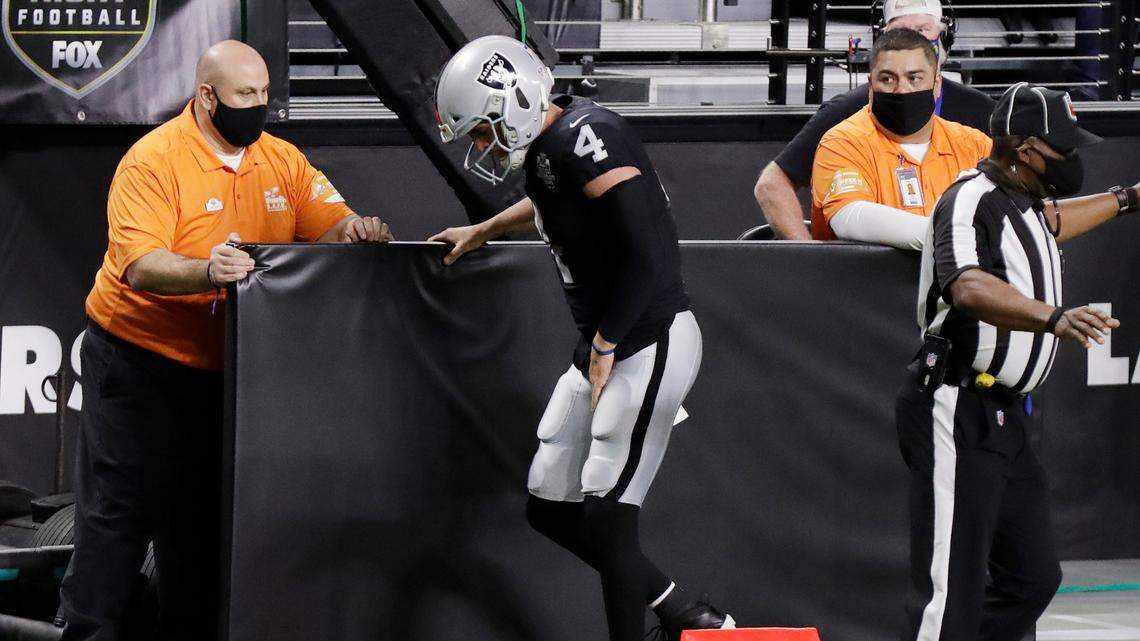 Las Vegas Raiders quarterback Derek Carr limps on the sidelines after a play against the Los Angeles Chargers on Thursday in Las Vegas.