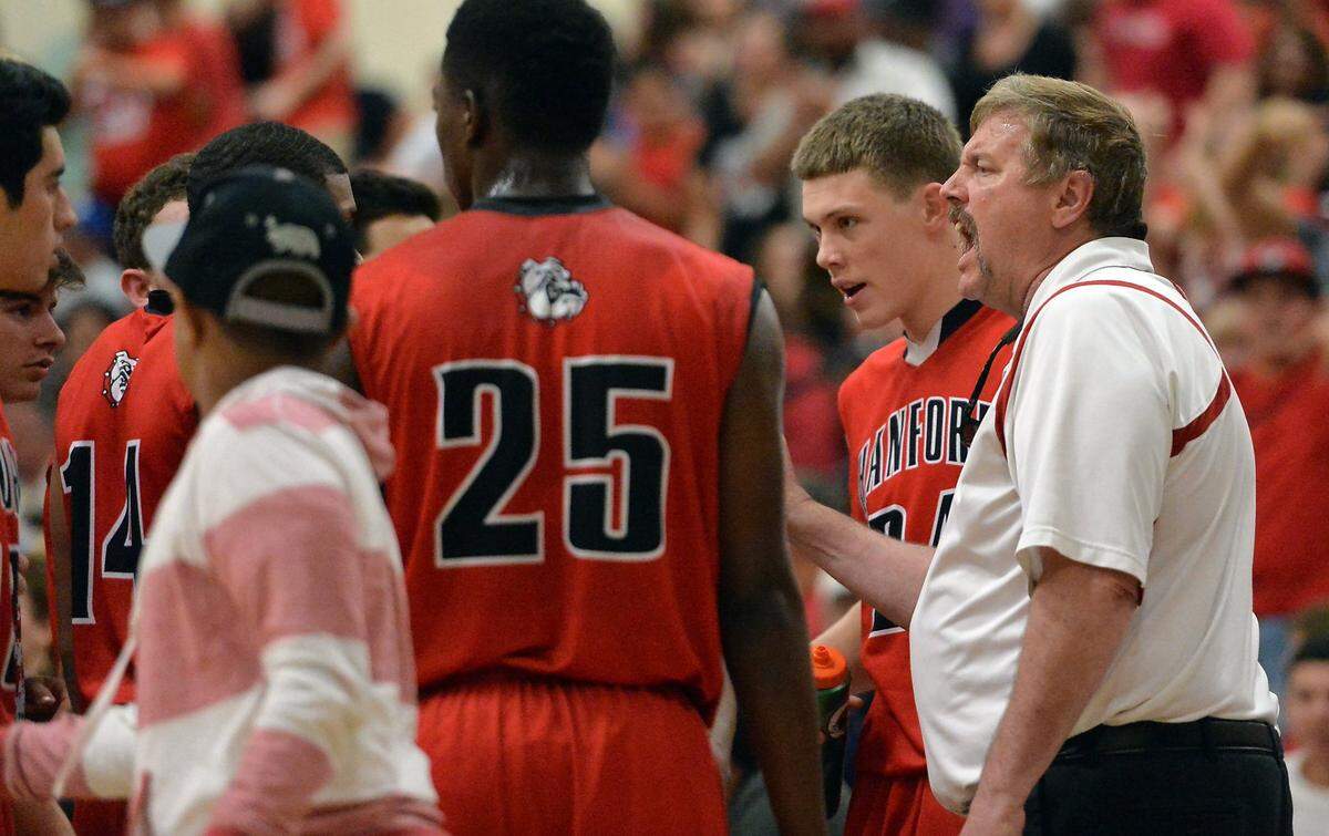 File photo of Hanford boys basketball head coach Brad Felder, right, checks in with his team during the Central Section Division II quarterfinals against Lemoore on Thursday, February 25, 2016 at Lemoore High School.