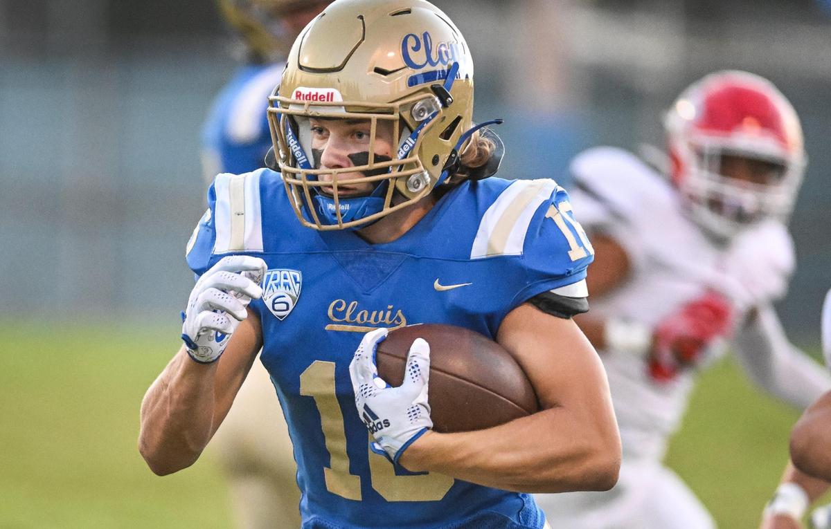 Clovis running back Noah Luginbill cuts to the outside on a run against Sanger during their game at Lamonica Stadium in Clovis on Friday, Aug. 25, 2023.