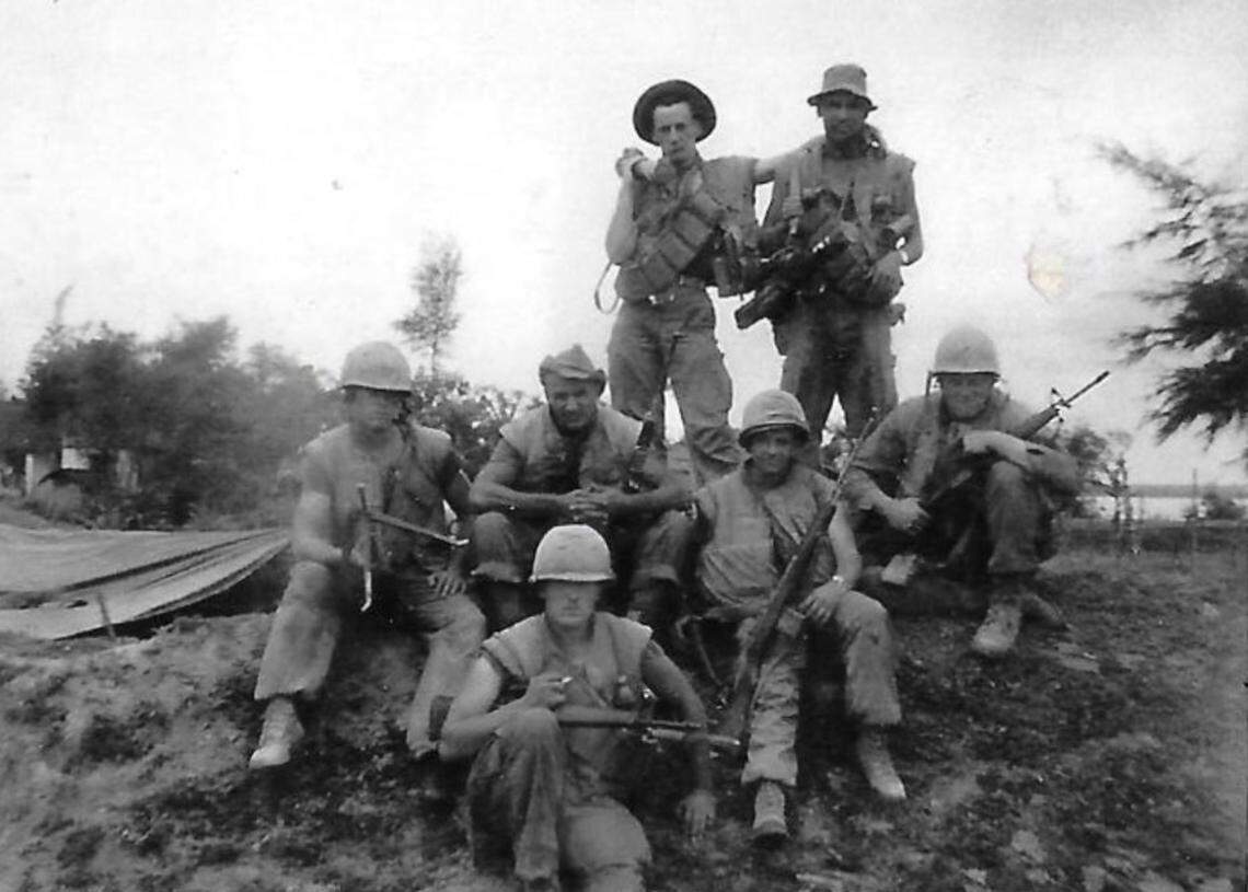 Marines in Vietnam in early 1968. Julio Martinez, top right; Mike Duerr, center front; and Bill McMyler, sitting on the ground, far right, are returning to Vietnam with Clem Edwards to return a Buddha statue that was stolen by a fellow Marine.
