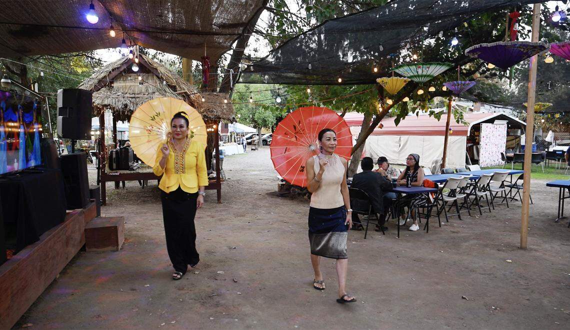 Connie Marez and Konny Phimmasone walk through the Lotus Pond and Night Market Friday night, Oct. 10, 2025 near Sanger. The night market was opened earlier this year celebrating the lotus flower and community. The night market which offers food, music, karaoke and more is located between Fresno and Sanger.