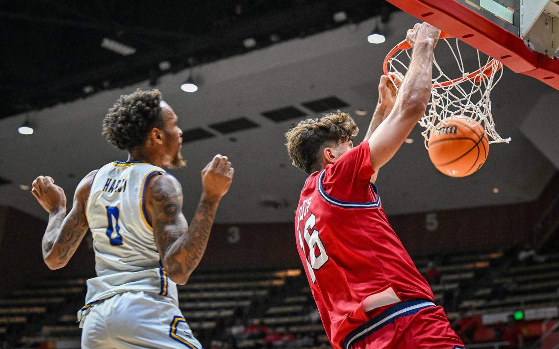 Fresno State's Wilson Jacques, right, dunks the ball in front of CSU Bakersfield's CJ Hardy during their non-conference game at Selland Arena in downtown Fresno for the “Return to Selland” game on Sunday, Nov. 30, 2025.