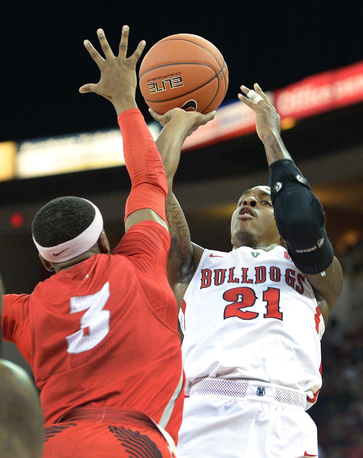Fresno State guard Deshon Taylor, right, takes a jump shot while defended by New Mexico’s Keith McGee during the Bulldogs’ 82-70 victory at the Save Mart Center in Fresno on Saturday, Feb. 2, 2019. Taylor had 20 points with seven rebounds and four assists for the Bulldogs, who are 16-5 and 7-2 and tied for second in the Mountain West Conference.