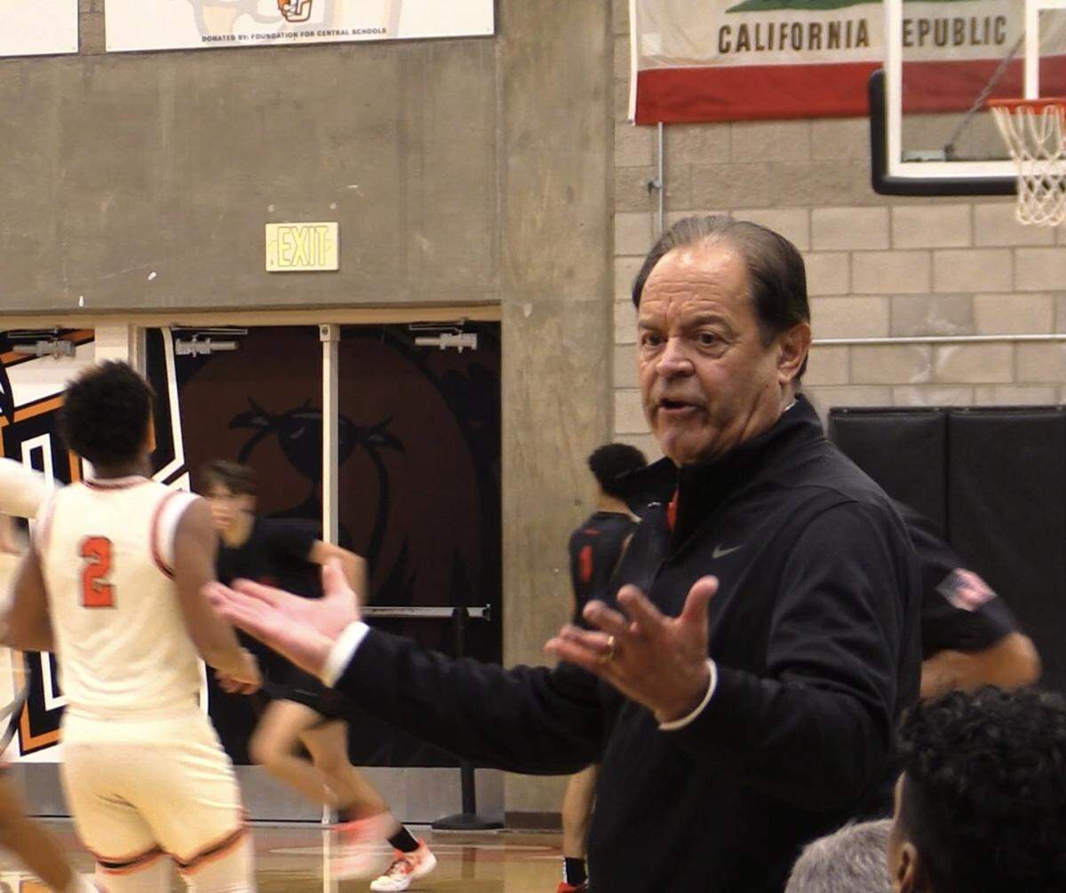 Buchanan High coach Tom Orlich looks at the bench during a high school basketball game against Central.
